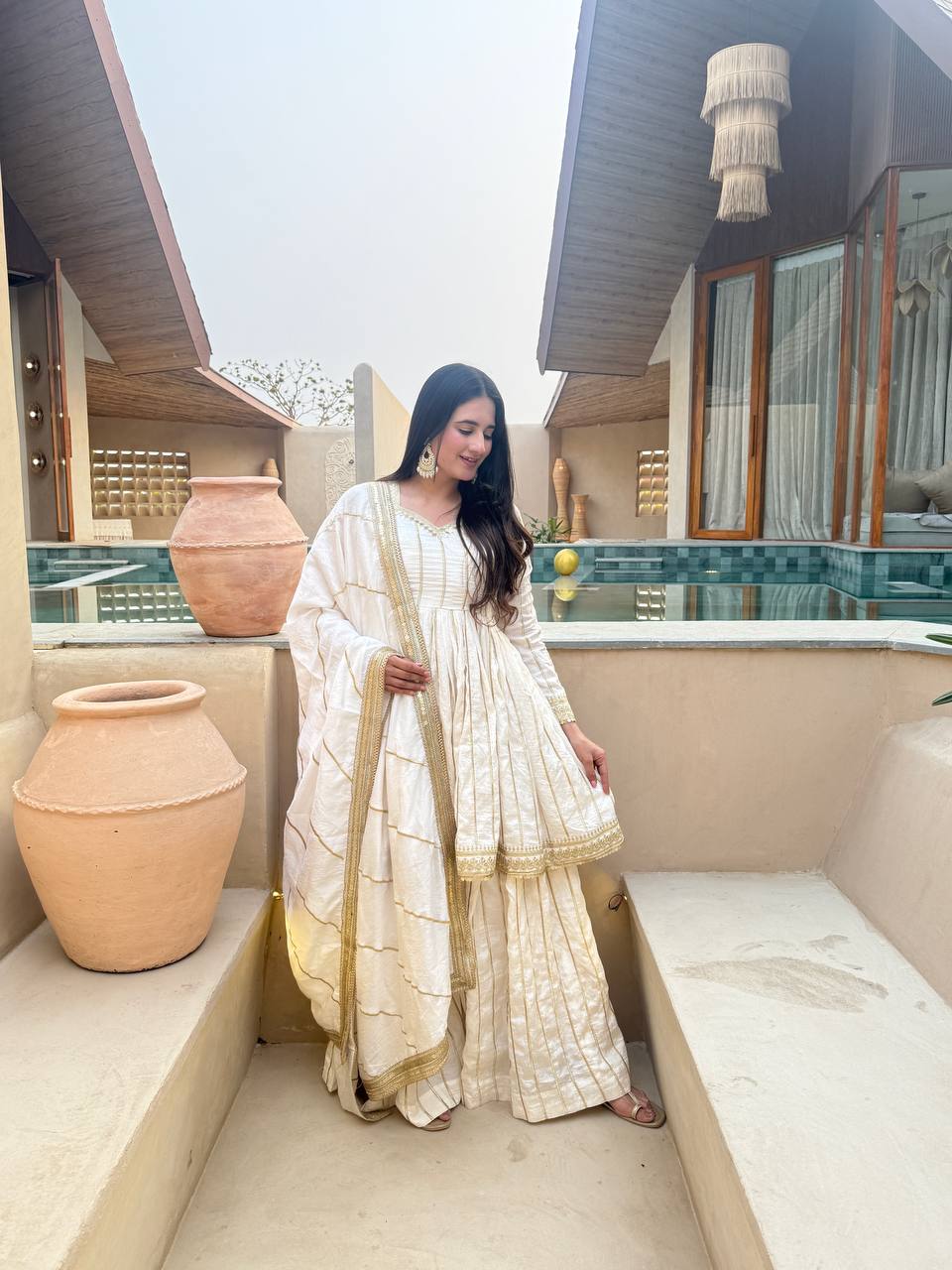 Radiant Rose Pink Flared Peplum Kurti and Sharara Set Embellished with Luminous Gold Zari Stripes and Sequined Borders
